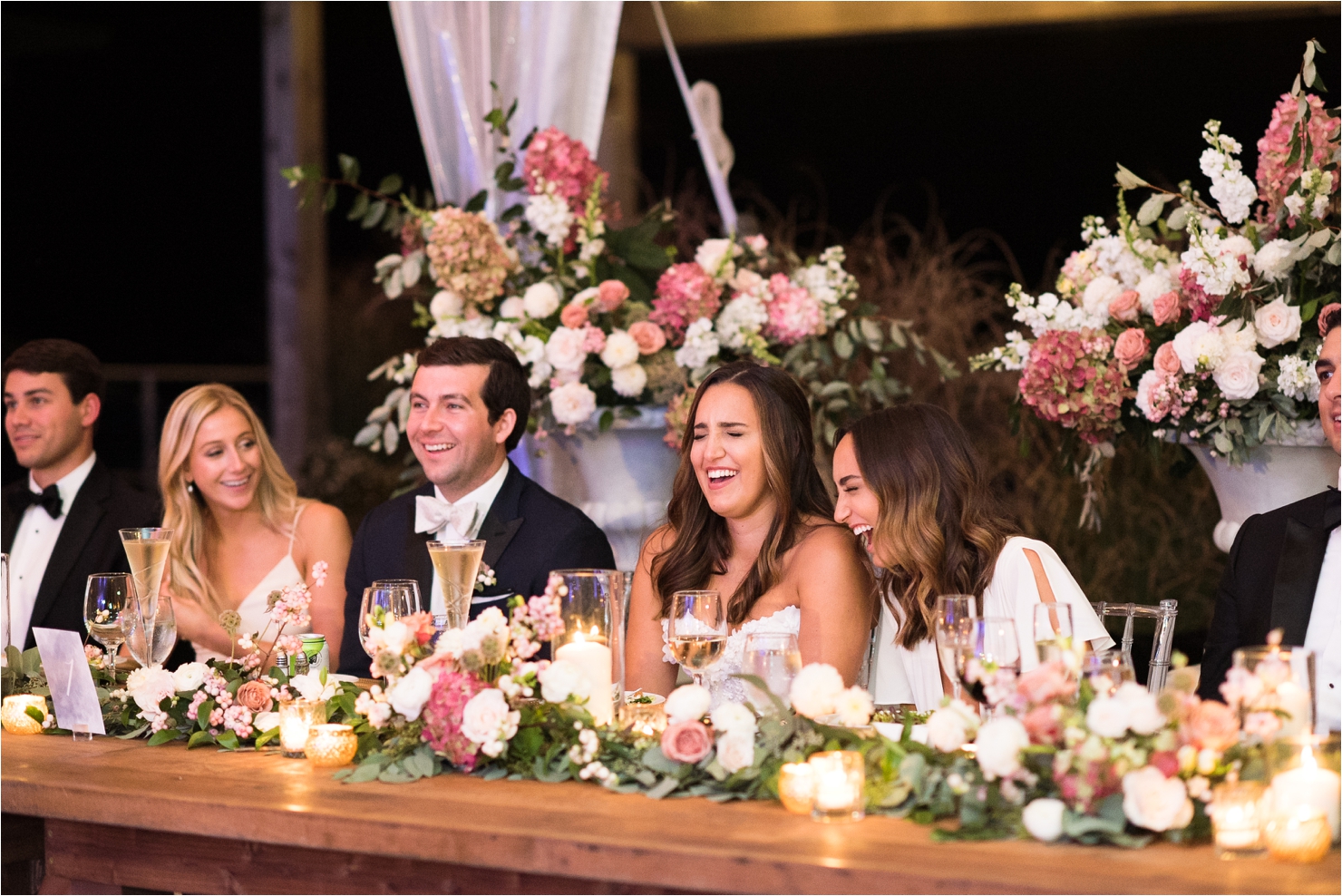 Bride and Groom Laughing at Speech Wedding Photos